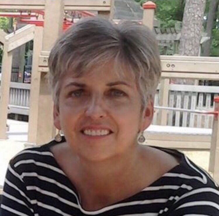 Photo of Nancy Cordrey wearing a black and white horizontal-striped shirt outside.